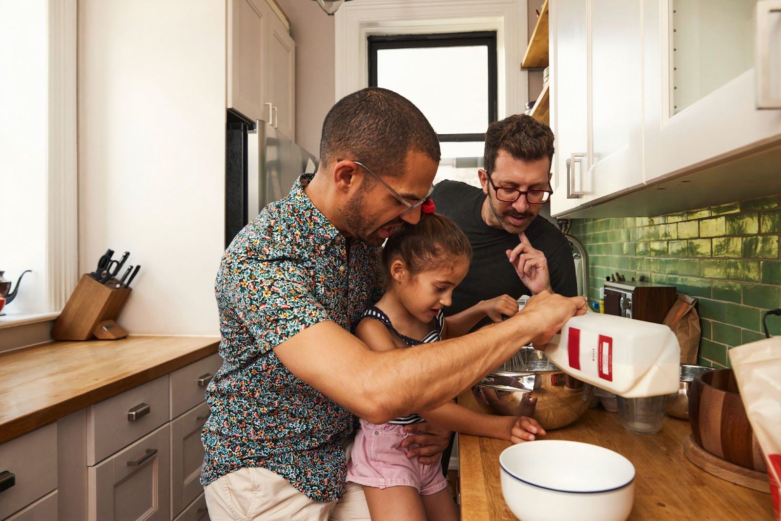 Two men baking with their kid