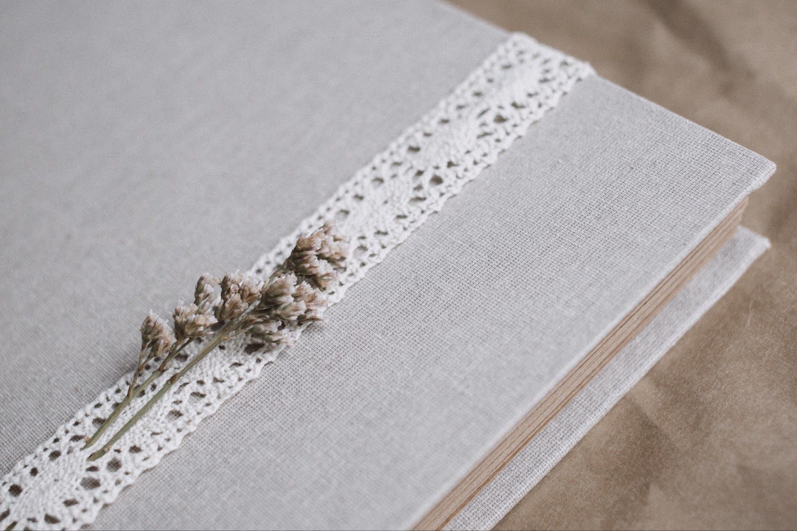 scrapbook with lace and flower attached to cover